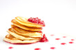 Pancakes on the white plate with raspberry jam