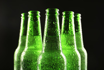 Poster - Glass bottles of beer on dark background