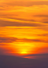 bright sunset in cirrus fiery clouds - vertical nature backgroun