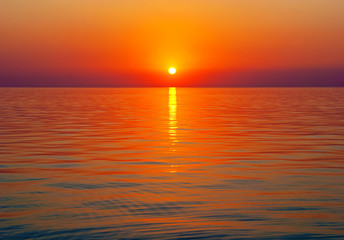 Poster - Bright sunset above tranquil sea surface with golden sun path