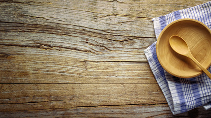 Wooden bowl ,fork and spoon on wooden background