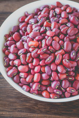 Wall Mural - Adzuki bean or red bean in white bowl on wood background