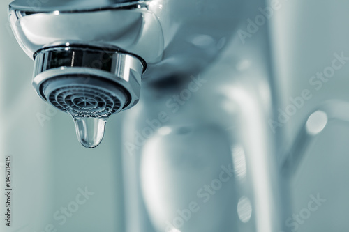 Fotomural Tap with dripping waterdrop. Water leaking, saving.