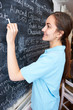 © highwaystarz - Waitress In Restaurant Writing Menu On Blackboard