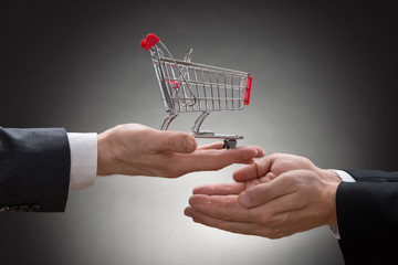 Businesspeople Hands With Shopping Cart