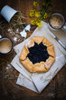 Galette with blueberries on rustic wooden table, top view