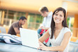 © seanlockephotography - College: Smiling Female Student Studying Outdoors With Laptop
