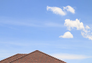 house brown brick roof, blue sky and cloud background.