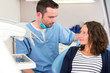 © Production Perig - Young attractive dentist explaning his work to a patient