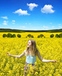 © vencav - Young happy woman on blooming rapeseed field in spring