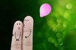 Finger cartoon holding pink balloon on green bokeh background , concept  background