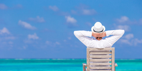 Young man enjoying summer vacation on tropical beach