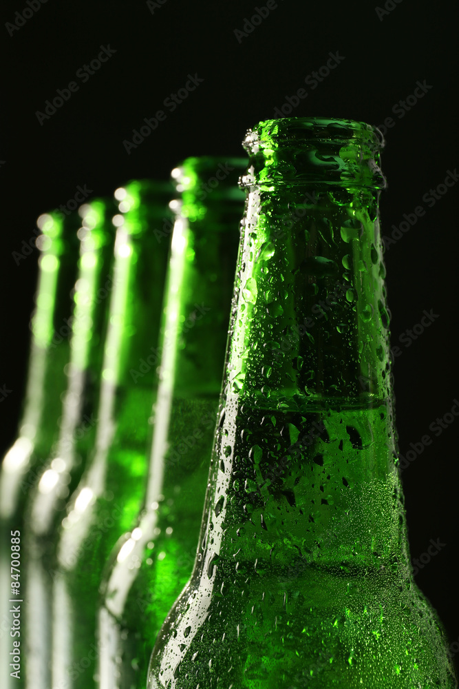 Glass bottles of beer on dark background