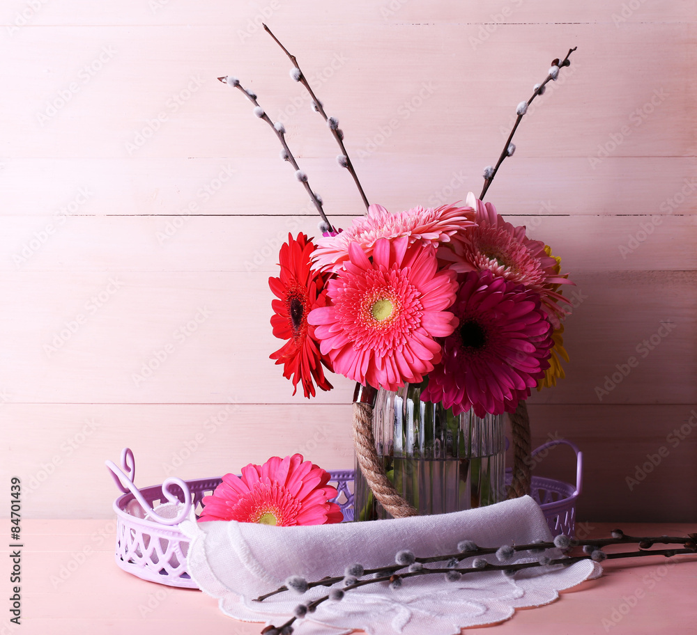 Beautiful bright gerberas in vase on wooden background