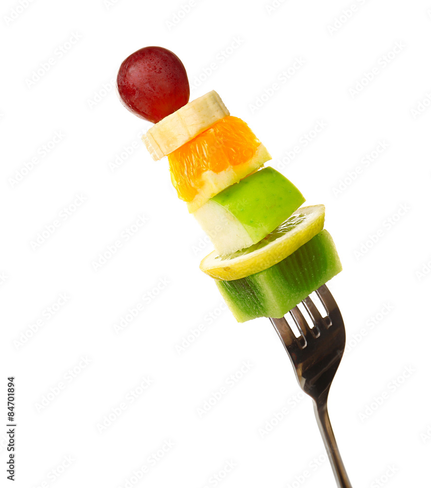 Snack of fruits on fork isolated on white
