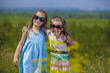 © kuzmichstudio - Kids in sunglasses in a meadow playing