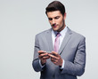 © Drobot Dean - Handsome businessman using smartphone