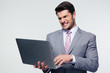 © Drobot Dean - Angry businessman using laptop