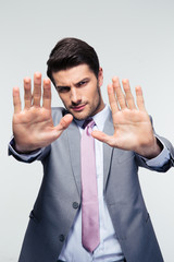 Businessman showing stop gesture