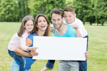 Wall Mural - happy family with copy space board 