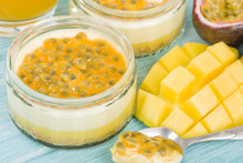 Mango & Passion Fruit Cheesecake - Individual Potted Dessert Made With Mango And Passion Fruit Whipped Cream And A Biscuit Base, Topped With Passion Fruit Pulp.
