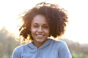 Wall Mural - Happy smiling young woman with curly hair