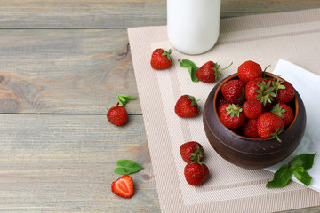 Poster - Fresh strawberries in a bowl  on a wooden background