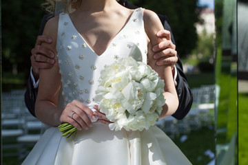 Wall Mural - Beautiful wedding bouquet in hands of the bride