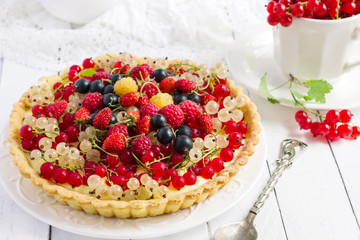 Tart with fresh berries on a white background