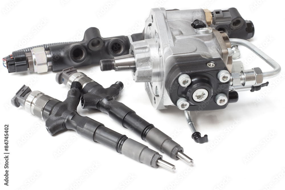 Two new solenoid injectors for diesel fuel lying on a white background ...