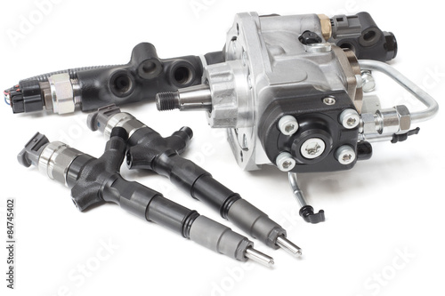 Fotografía Two new solenoid injectors for diesel fuel lying on a white background with a ro