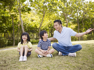 Wall Mural - asian father and children having an interesting conversation