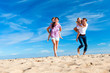 © dglimages - Family on the Beach Flying a Kite