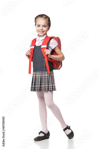 Cute smiling schoolgirl in uniform standing on white background Stock ...