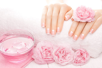 french manicure with rose flowers. spa