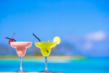 Wall Mural - Two tasty cocktails on tropical white beach