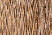 A Wooden Background With Vertical Reeds