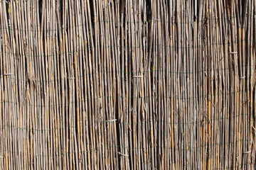  A wooden background with vertical reeds