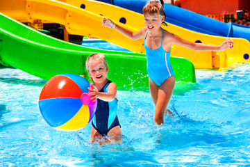 Wall Mural - Child on water slide at aquapark.