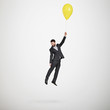 © ArtFamily - man flying with yellow balloon
