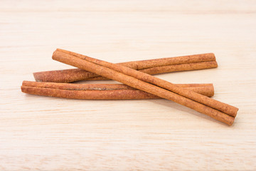 Wall Mural - Cinnamon sticks on wooden table