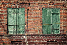 Old Window With Closed Shutters On A Brick Wall