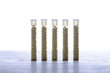five small glass tubes with homeopathy globules, white backgroun