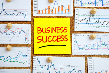 Wall Mural - business success handwritten on post-it with financial graphs