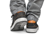 Reaching Leg Men In Gray Jeans And Street Shoes Isolated On Whit