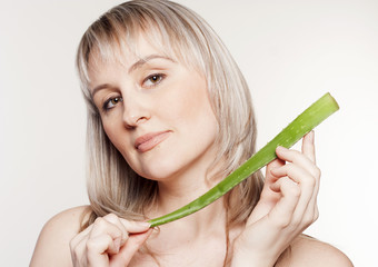 Young beautiful woman with aloe