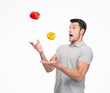 Young man juggling pepper