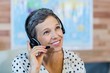 © WavebreakmediaMicro - Smiling travel agent sitting at her desk
