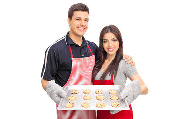 Wall Mural - Couple holding a pan full of chocolate chip cookies