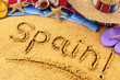 Spain word written in sand on a sandy beach background with star fish and accessories summer Spanish holiday vacation photo